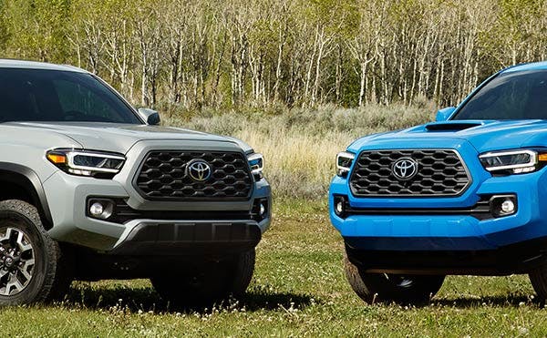 two toyota tacomas - front views - blue and gray exteriors