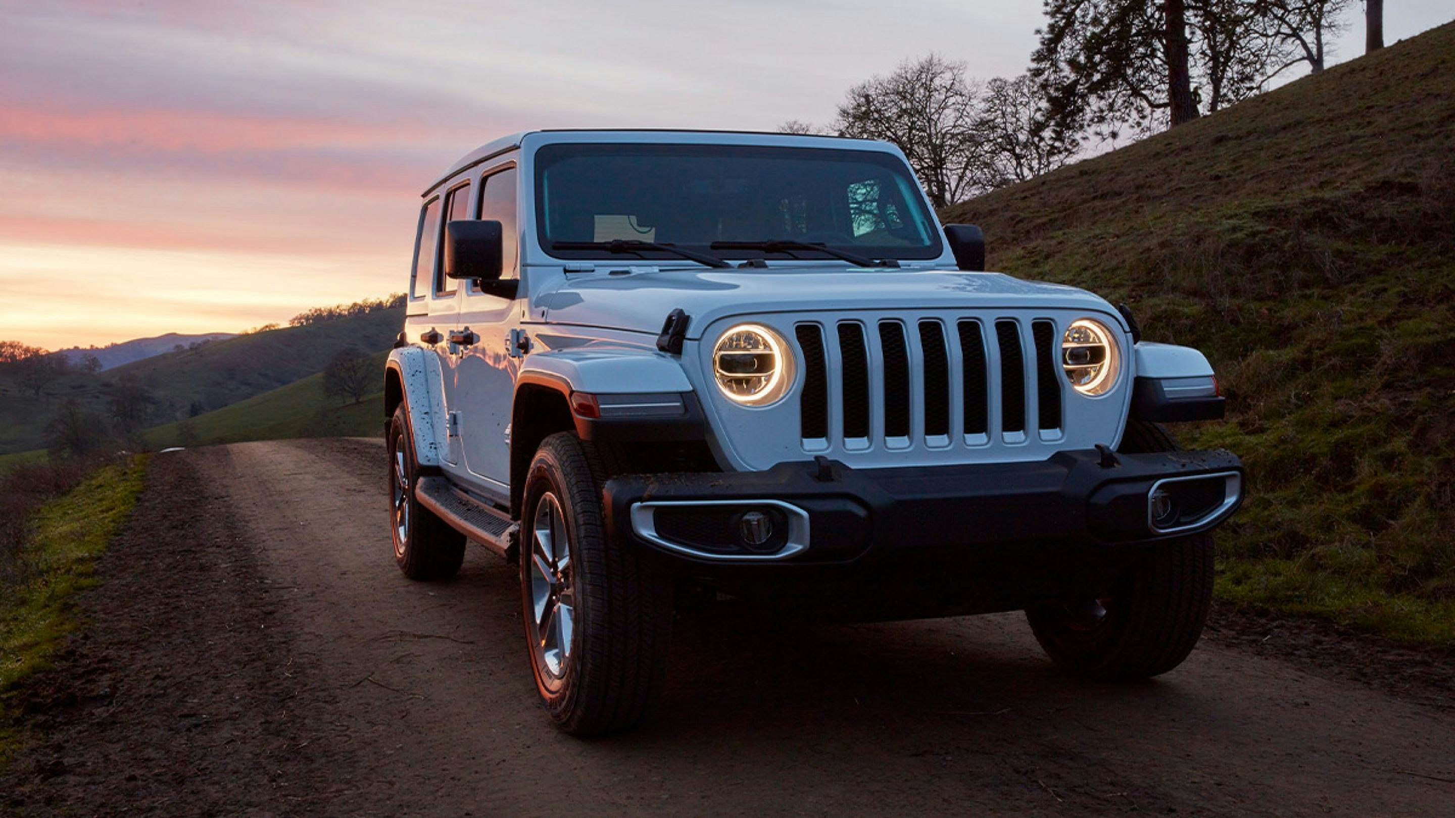 Jeep on a dirt road at sunset