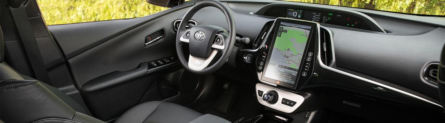 Close up view of a Toyota Prius Prime’s steering wheel and dashboard