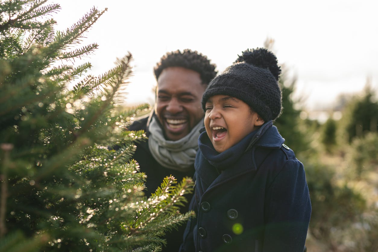 A father and daughter portrait at a tree farm