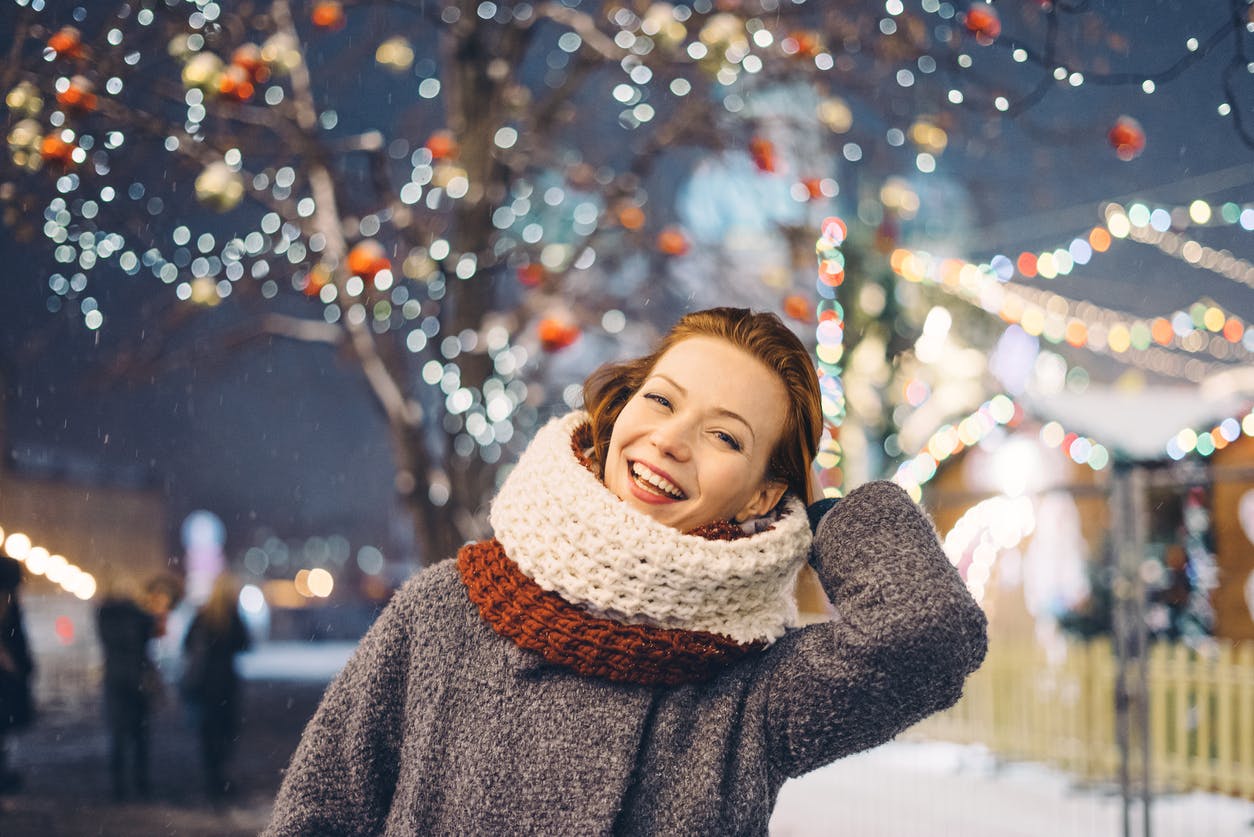 Happy woman at the Christmas market at night