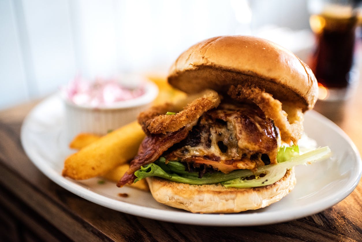 A cheese burger in a toasted brioche bun