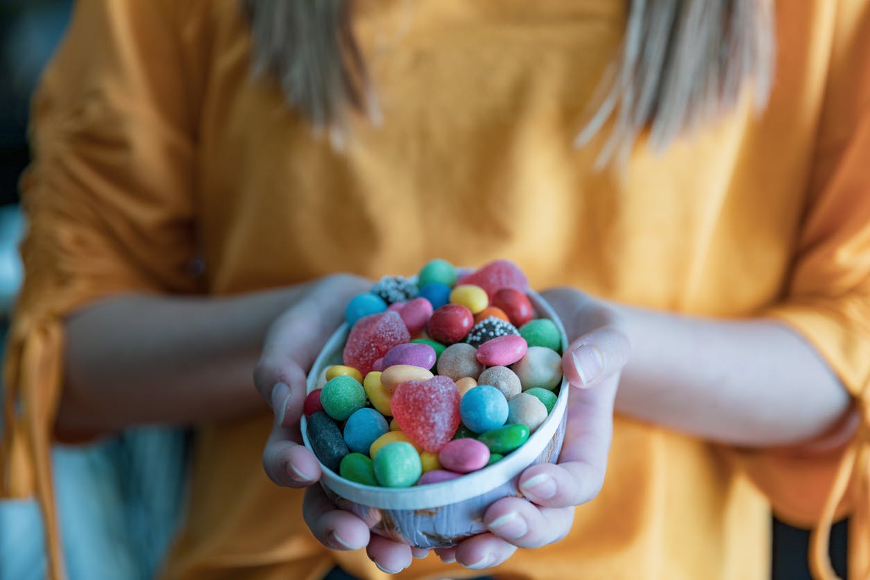 Girl holding Easter egg filled with candy