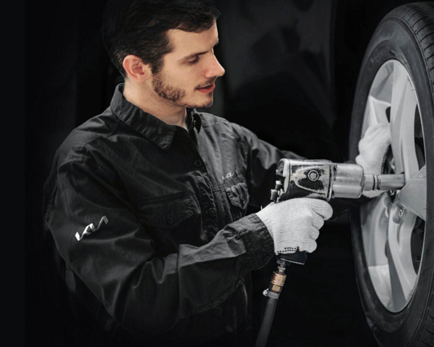 kia service technician fixing tires