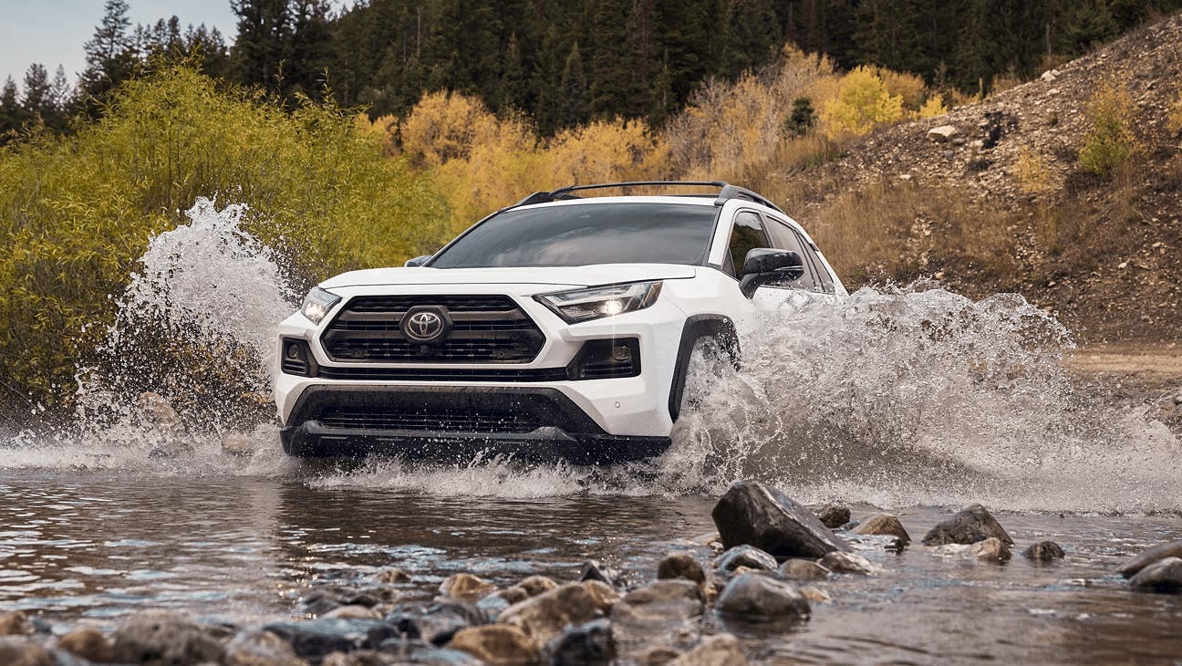 white 2022 rav4 driving through water