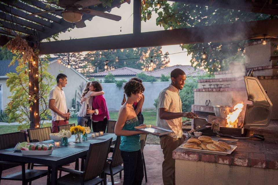 Friends grilling at a memorial day cookout.