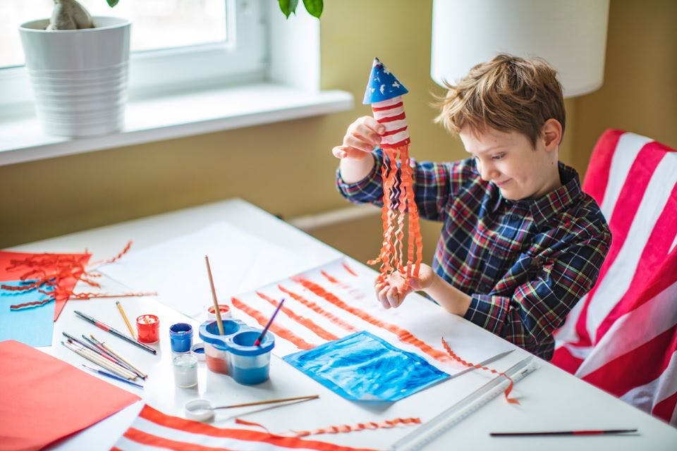 Little boy makes a patriotic Memorial Day streamer