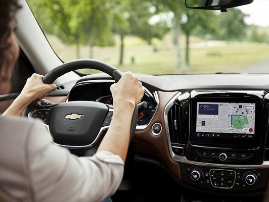 woman holding steering wheel showing navigation screen