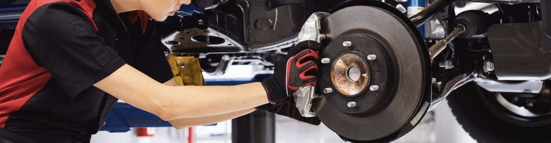 Toyota service tech putting rotors on vehicle