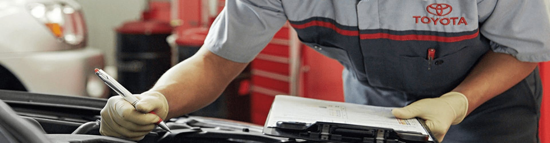 Toyota service technician performing inspection on vehicle