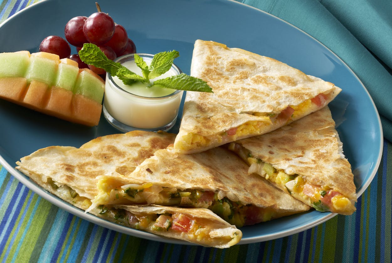 quesadilla made with cropped tomatoes, onions bell peppers, cilantro, scrambled eggs and two types of cheese, Montery jack and Cheddar. Served with a yogurt dipping sauce and fruit.