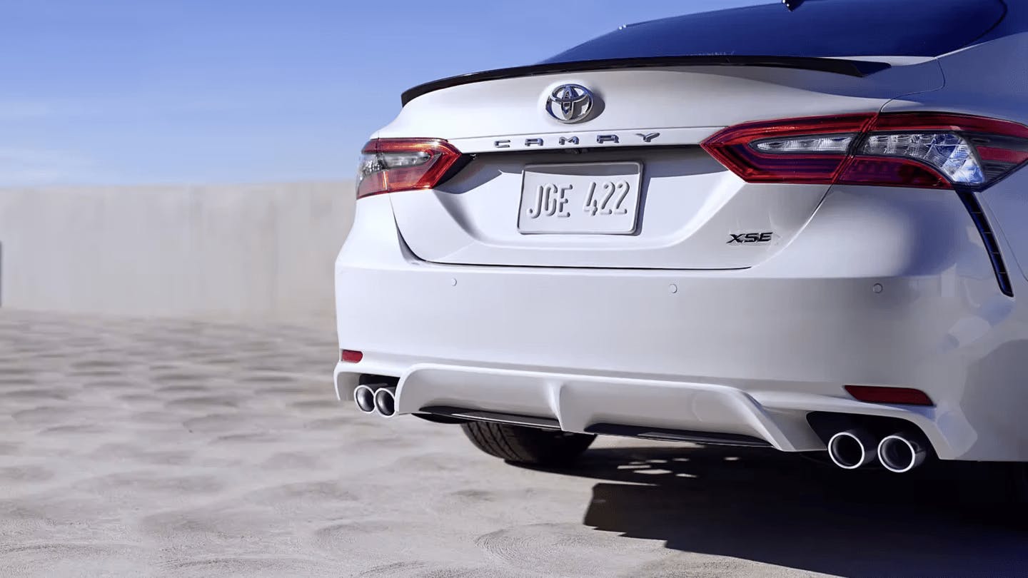 back view of white 2023 camry hybrid