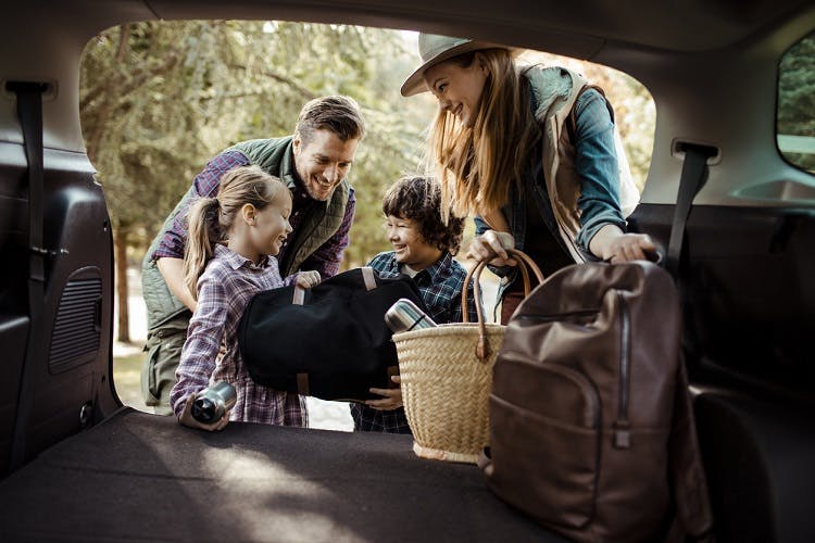 Close up of a young family packing up for a camping trip