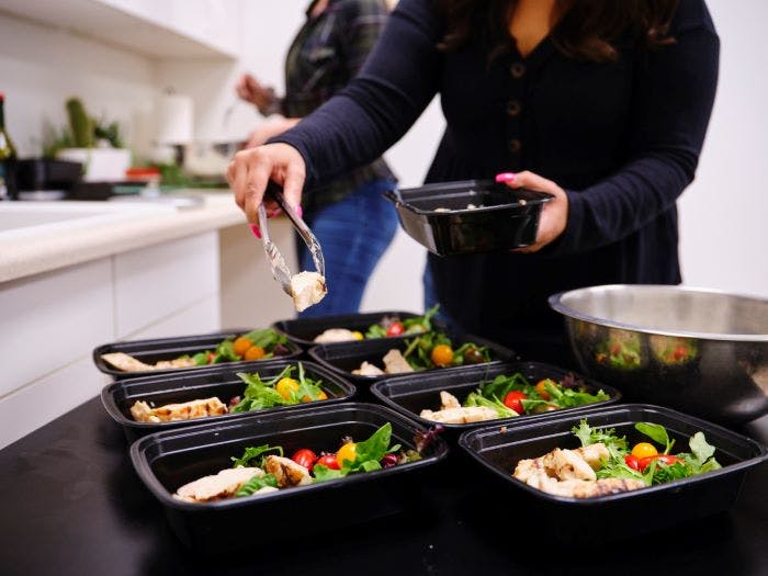 a woman prepares food for the week