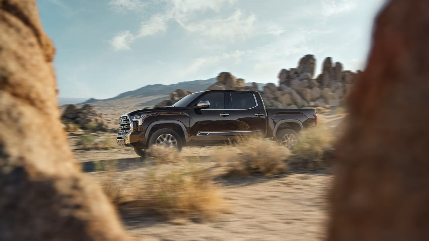 black 2023 toyota tundra driving in sand