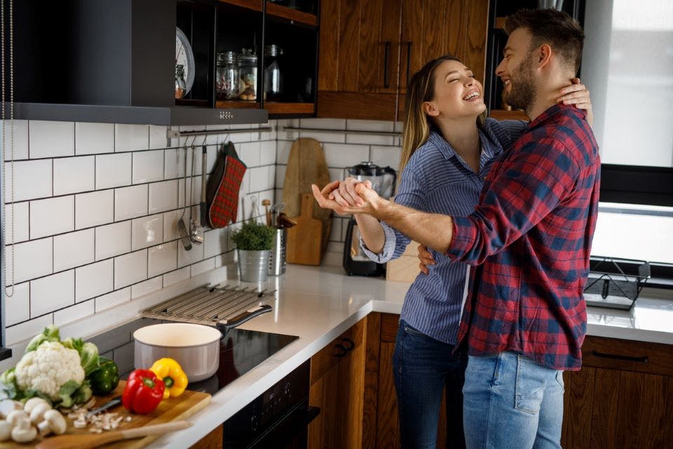 Couple dancing and cooking together on Valentine's Day