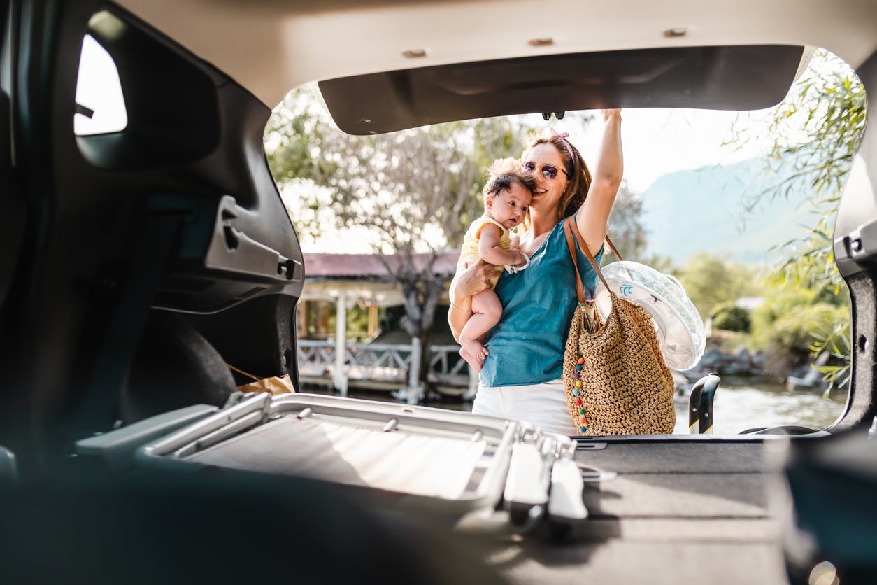 mother with baby closing back of SUV