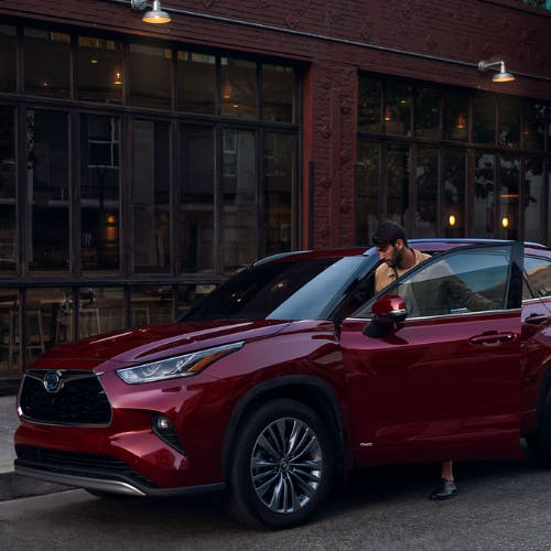 woman opening red suv door