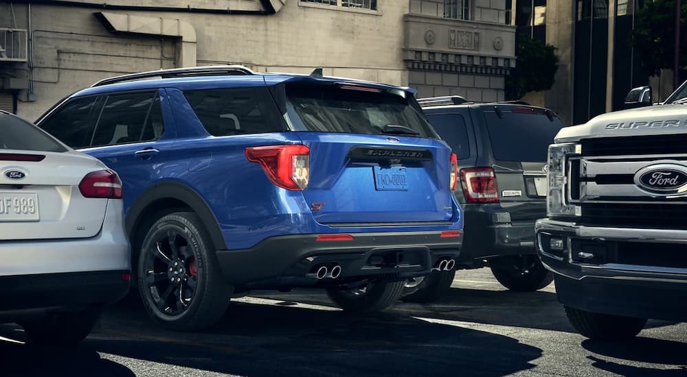 A blue 2023 Ford Explorer ST is shown from the rear in a parking spot after leaving a Ford dealer near Brattleboro, VT.