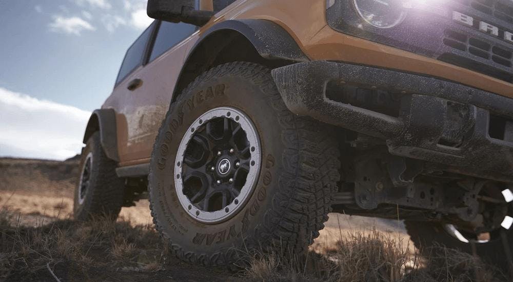 A close up of a yellow 2022 Ford Bronco Sasquatch Package off-roading is shown.