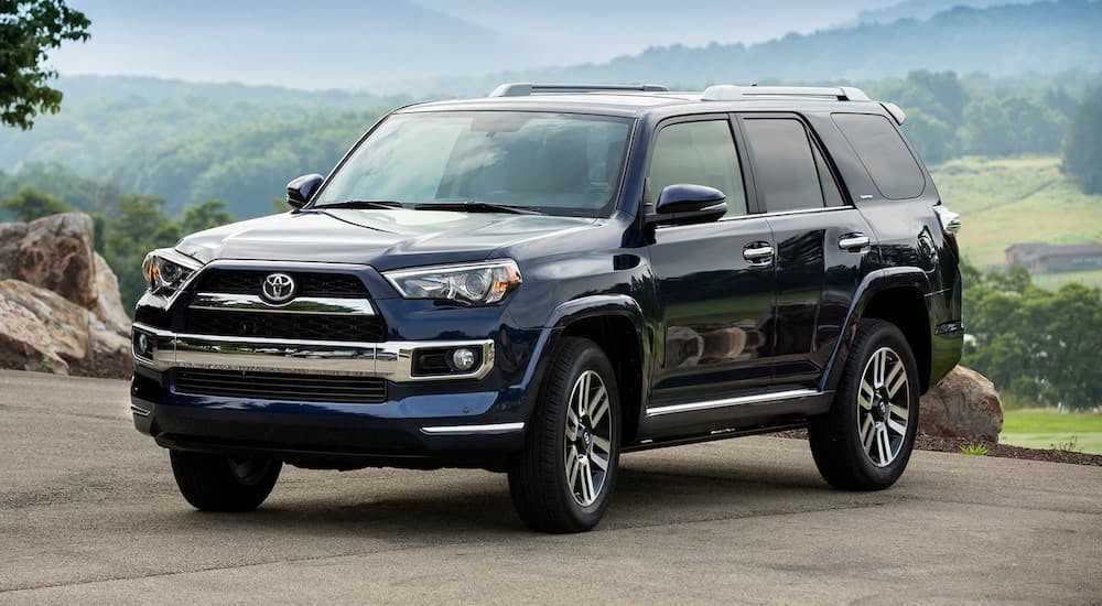 A blue 2018 Toyota 4Runner is shown parked overlooking an open valley.