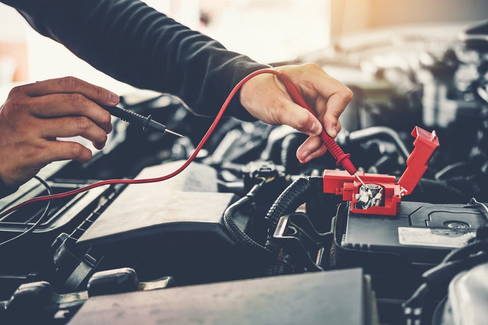 Have Peace Of Mind With ToyotaCare Technician Hands of car mechanic working in auto repair Service and Maintenance car battery