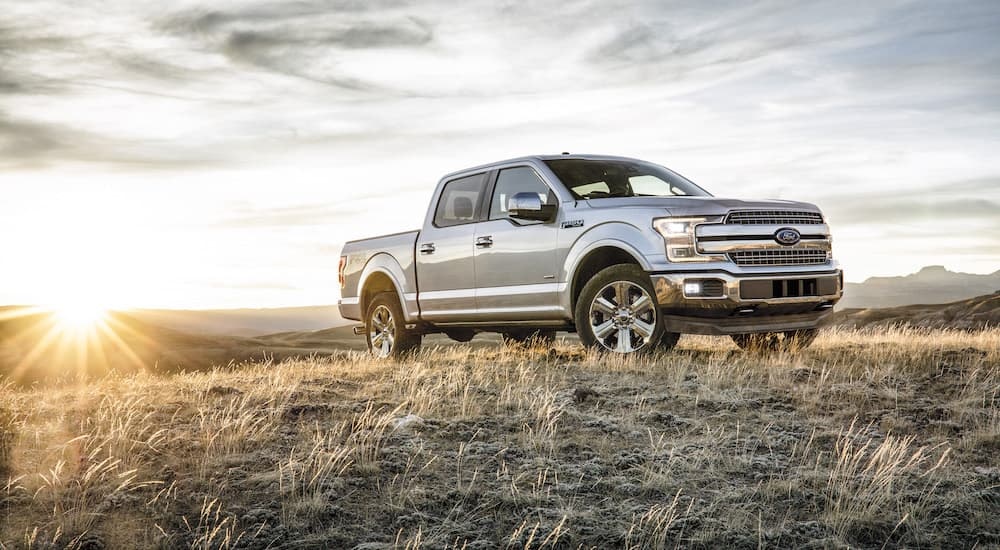 A silver 2018 Ford F-150 for sale near Keene, NH is shown parked on a field.