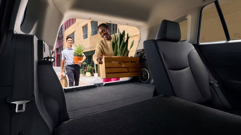 man and woman utilizing corolla cross cargo space man and woman utilizing corolla cross cargo space