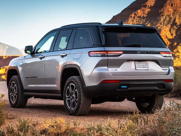 2023 Jeep Grand Cherokee 4xe parked on the gravel rear angle