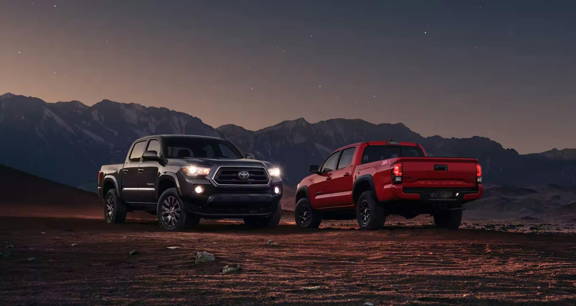 grey and red tacoma cars parked at night