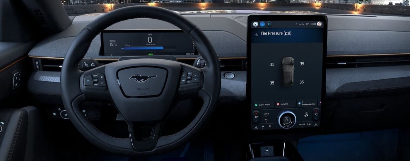 The black dash and infotainment screen are shown in a 2023 Ford Mustang Mach-E.