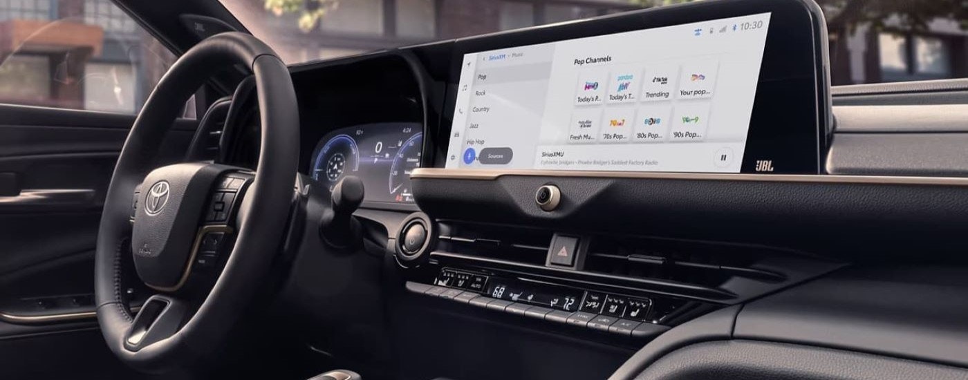 A close up shows music selections on the infotainment screen in a 2023 Toyota Crown Platinum.