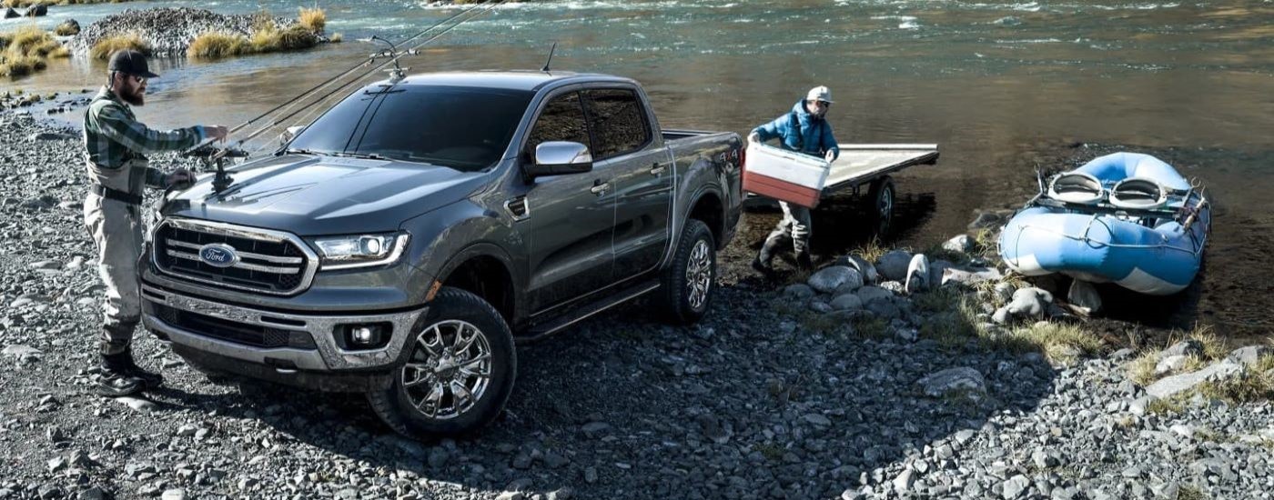 People are shown with fishing gear near a grey 2023 Ford Ranger Lariat.