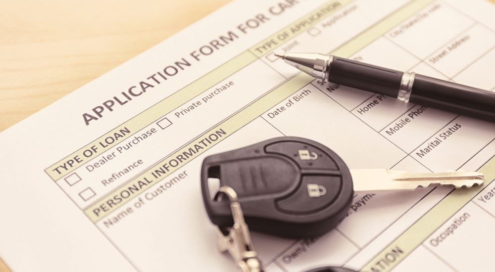 A car loan is shown at a dealership who does Bad Credit Car Loans Near Springfield, VT.