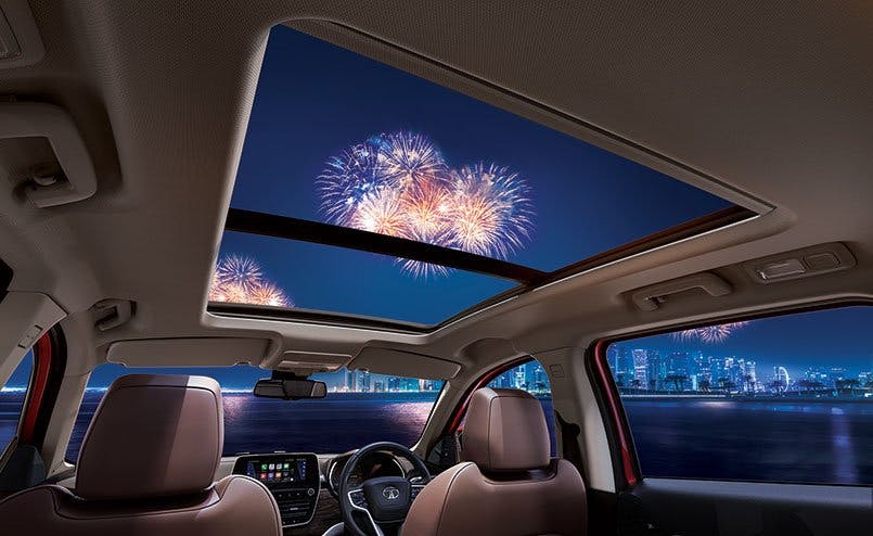 interior illustration of a vehicle underneath a sunroof with fireworks in the background