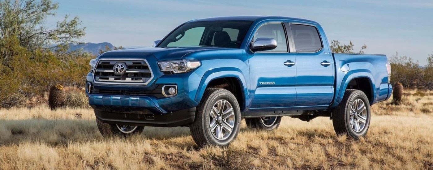 A blue 2016 Toyota Tacoma for sale near Keene, NH is shown parked on a field.
