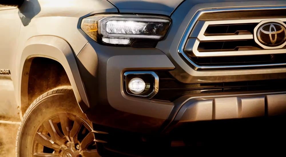 A close up shows the front of a grey 2023 Toyota Tacoma for sale near Keene, NH.