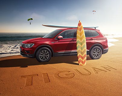 VW Tiguan on a beach with surf boards