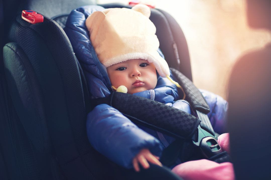 a baby inside a booster seat