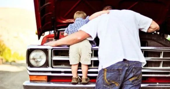 man and son looking into engine bay