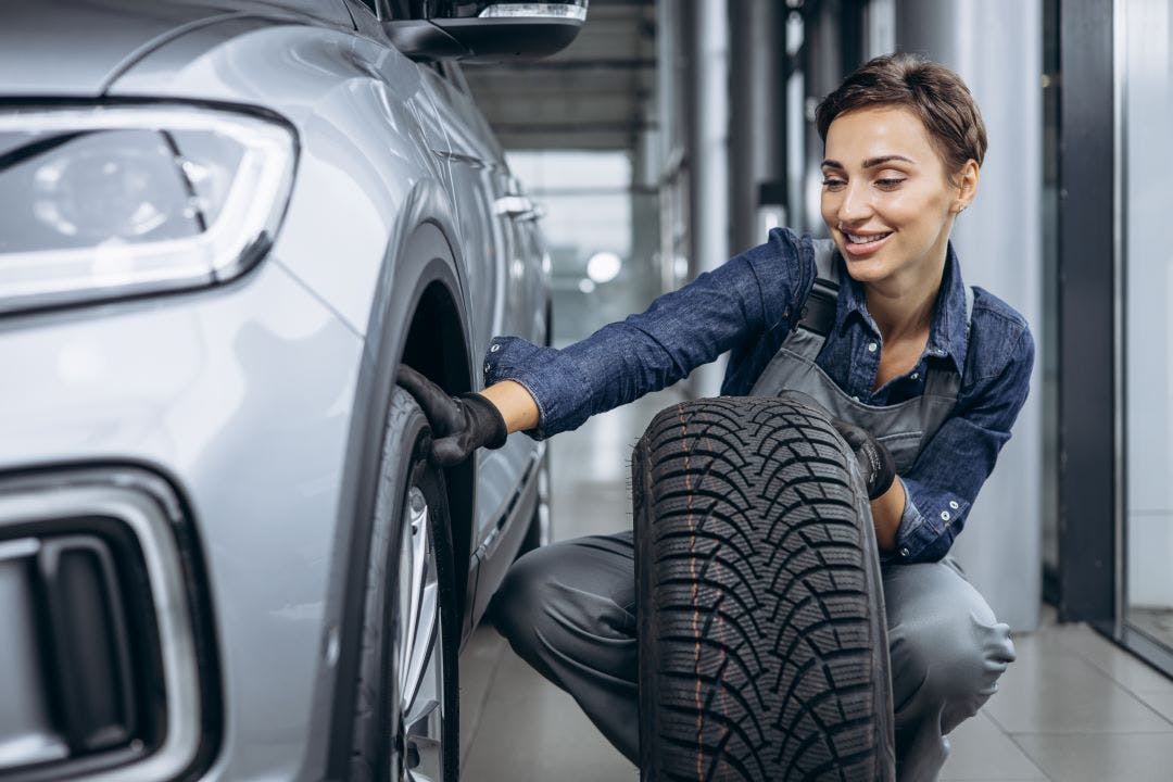 a woman changing her tires