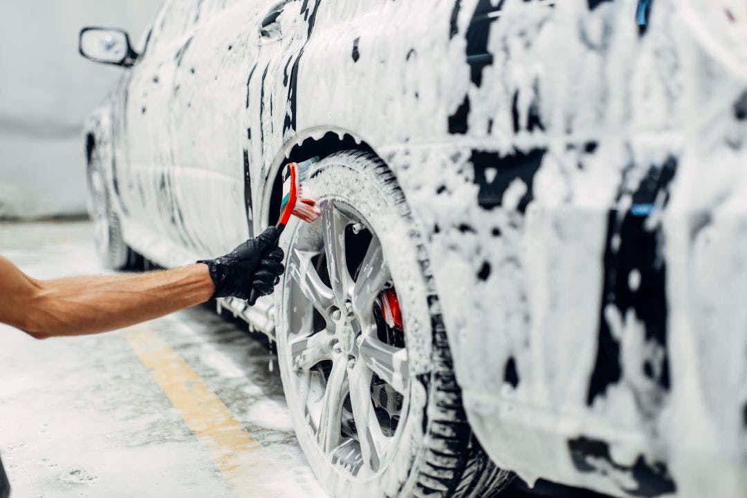 a person detailing a vehicle