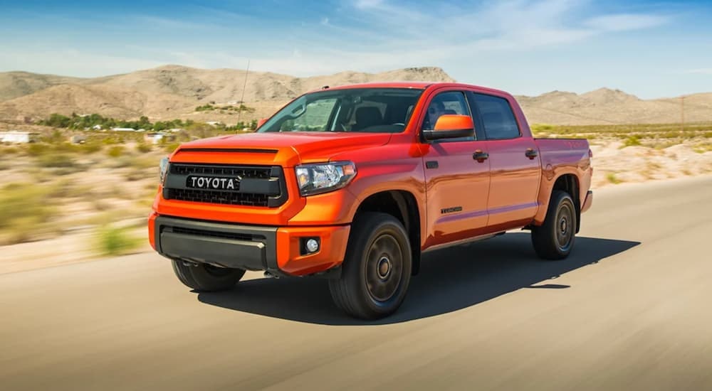 An orange 2015 Toyota Tundra is shown from the front at an angle after leaving a dealer that offers bad credit auto loans near Greenfield, MA.