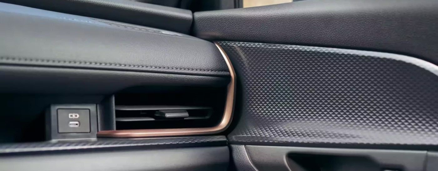 A close up shows a black vent and dash in a 2024 Toyota Grand Highlander.