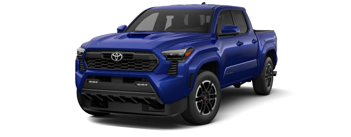 A blue 2024 Toyota Tacoma TRD Sport is angled left.