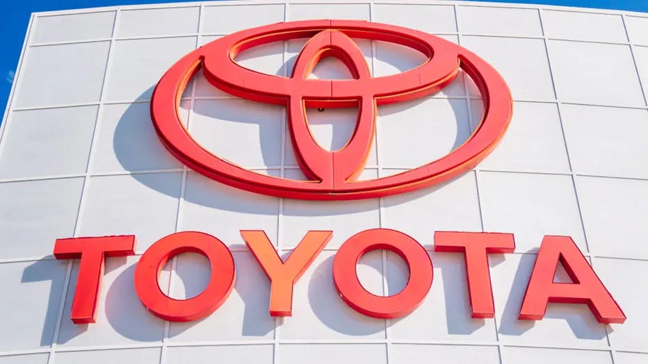 Toyota logo on a sign under a bright blue sky