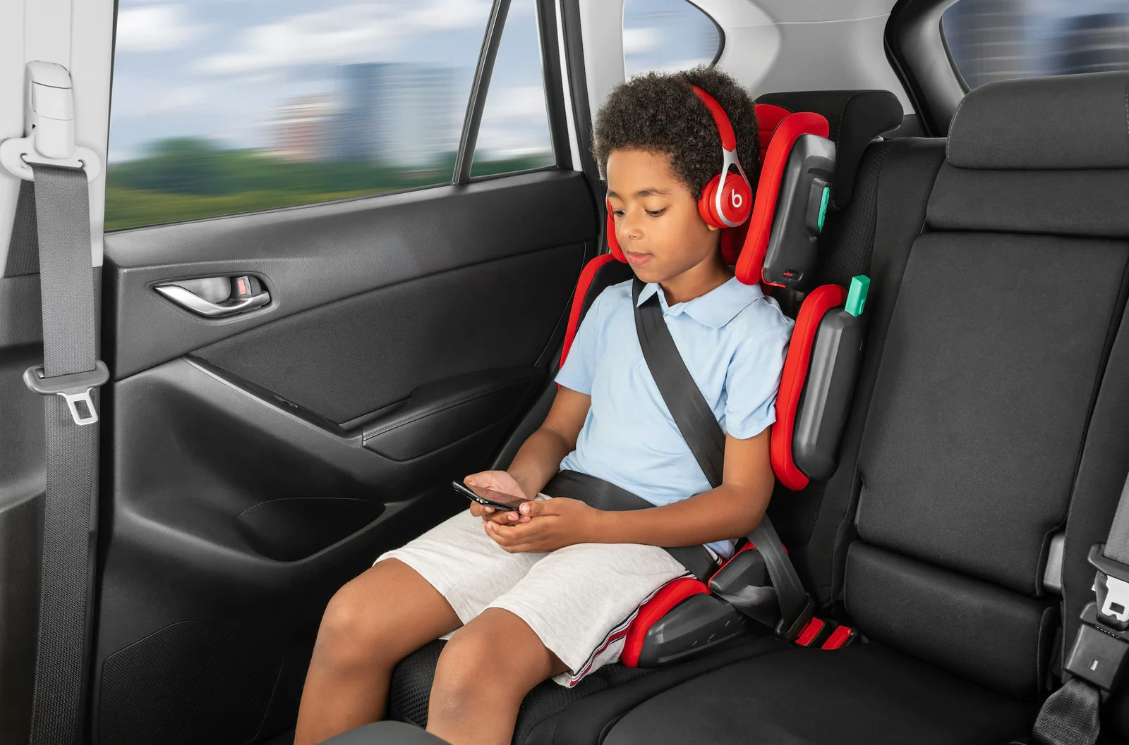 boy in a booster seat in a car