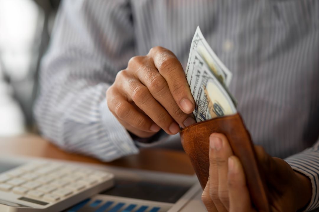 Man taking money out of his wallet