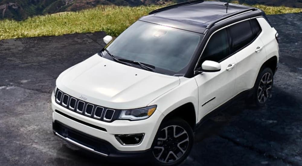 A white 2020 Jeep Compass is shown from the front at a high angle.