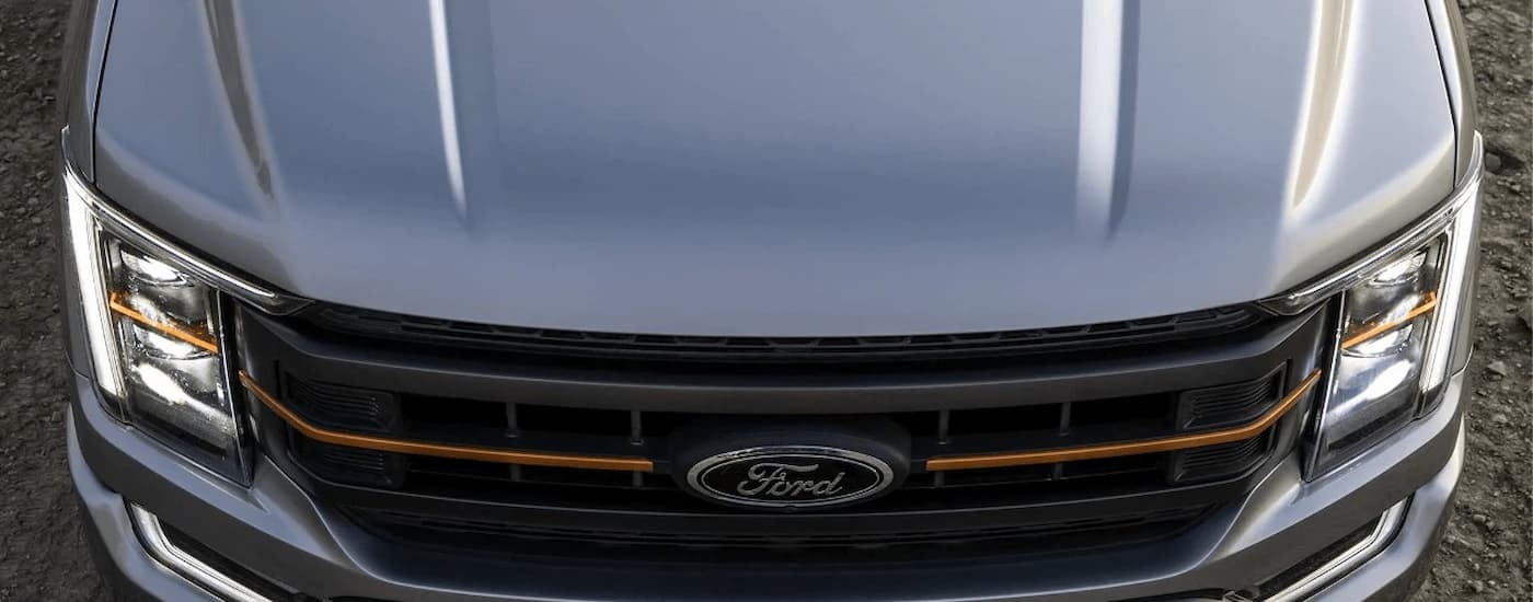 A close up of the grey hood on a 2023 Ford F-150 Tremor for sale is shown at a dealership.